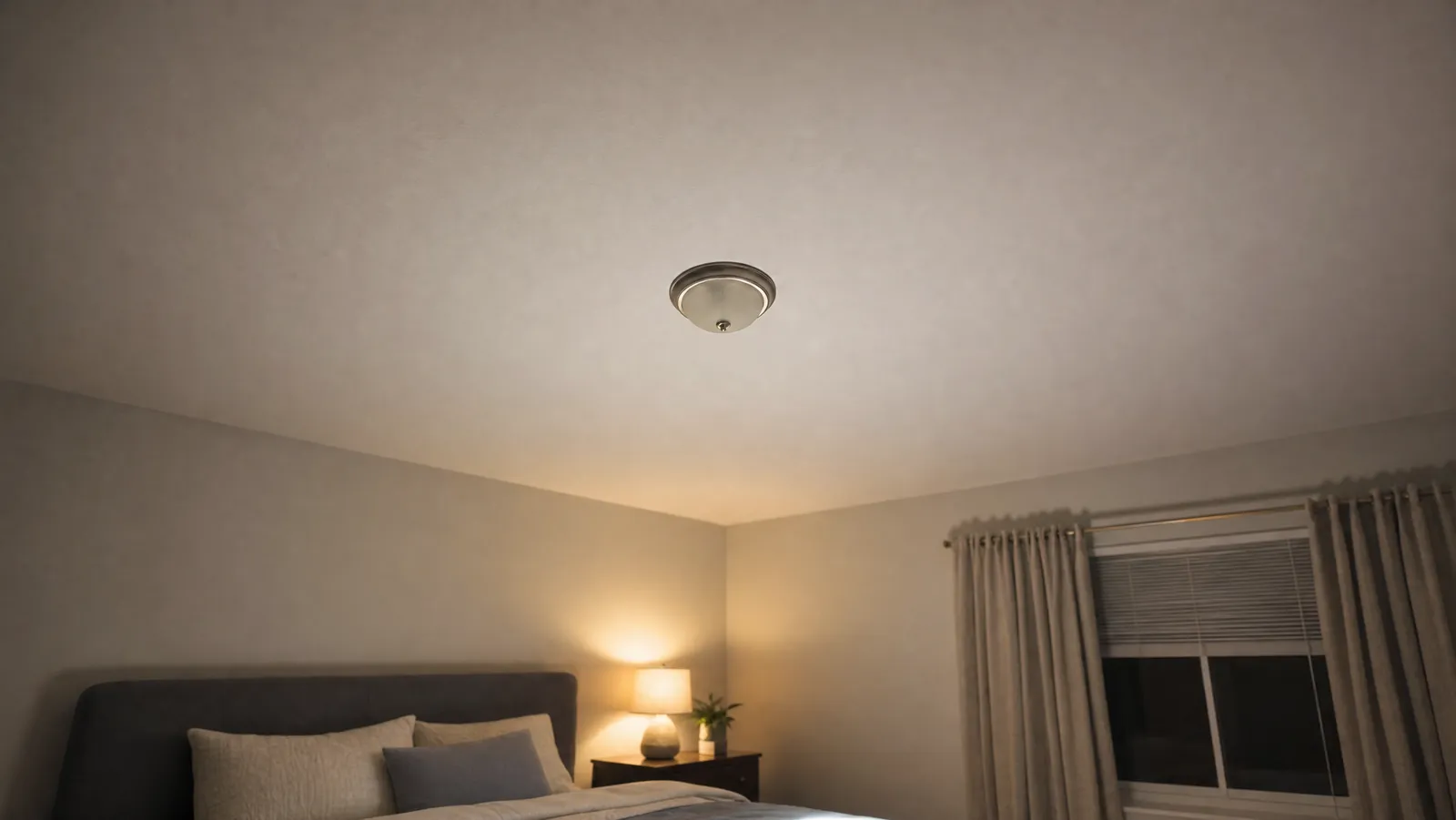 Looking up at a plain white apartment ceiling from a quiet bedroom at night