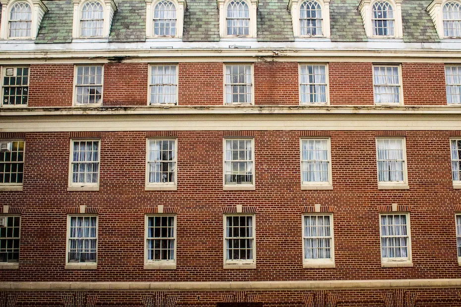 Heavy floor-to-ceiling curtains drawn across a large apartment window